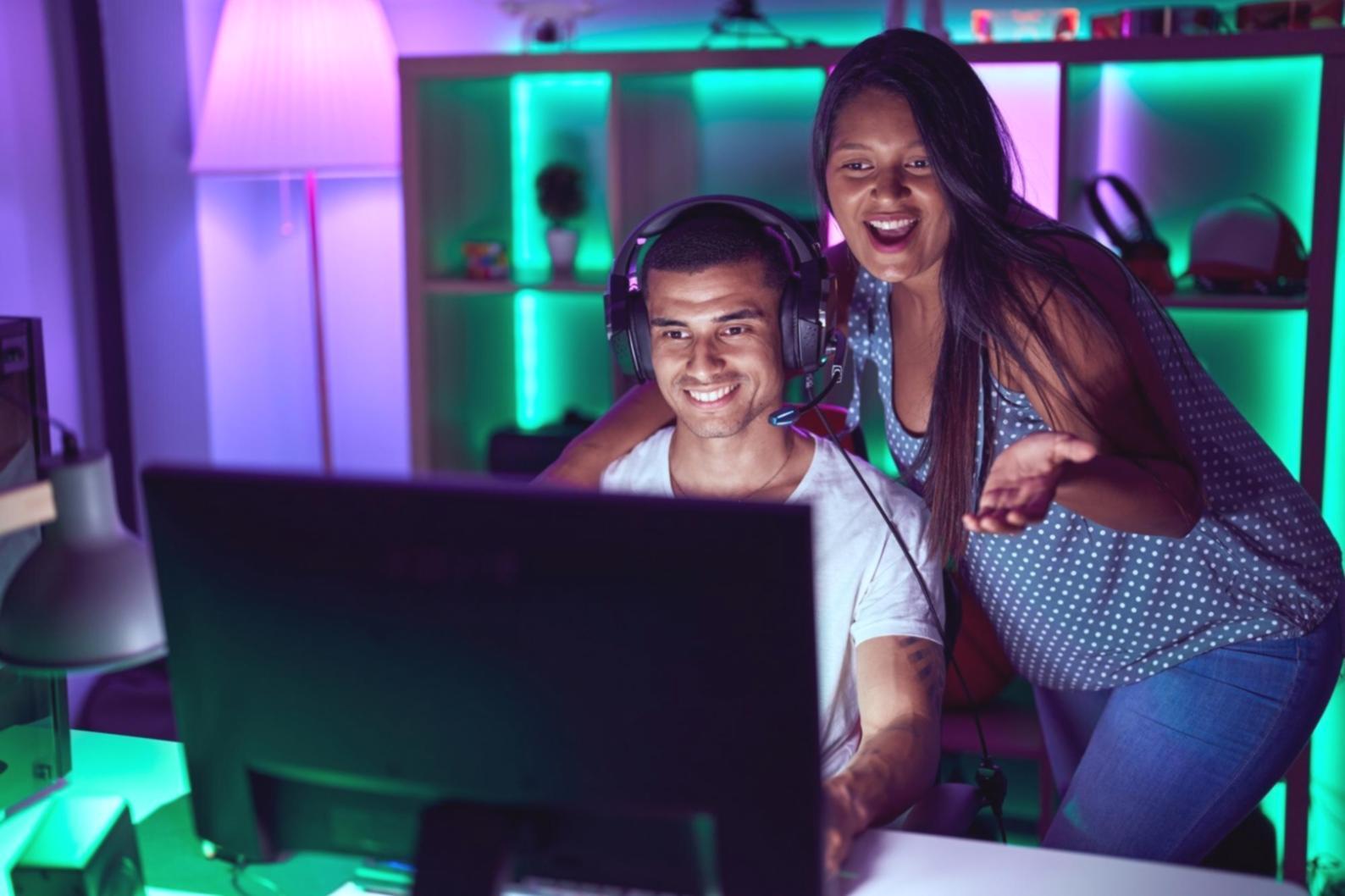 Mobile game development workspace showing code and testing devices